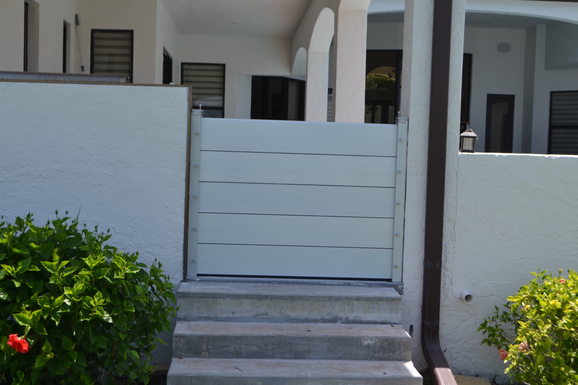 Rubicon deployable aluminum flood panels installed across a Florida home opening